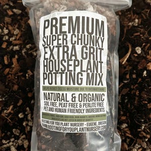 May include: A clear plastic bag filled with a dark potting mix. The label reads "PREMIUM SUPER CHUNKY EXTRA GRIT HOUSEPLANT POTTING MIX." The mix is natural and organic, soil-free, peat-free, and perlite-free, with pet and human-friendly ingredients.