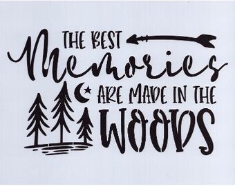 May include: A white background features black text that reads "THE BEST Memories ARE MADE IN THE WOODS." An arrow and three stylized pine trees are also included in the design. The text is in a mix of cursive and block lettering.