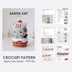 tabby crochet amigurumi santa cat sitting in the chimney. Cat in red santa hat entering the chimney. 100% cotton yarn beige brown tabby cat Christmas crochet softie on the white christmas trees background. Digital pdf download