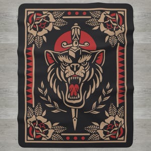 May include: Black blanket with a tattoo-style design featuring a snarling wolf with a dagger through its head, set against a red sun. The design includes red and tan roses, leaves, and a red and tan border.