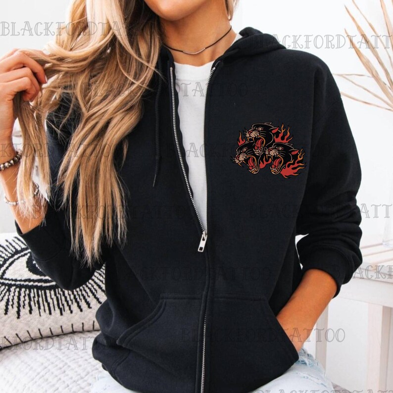 May include: Black zip-up hoodie with a graphic of three black panther heads with flames on the left chest.