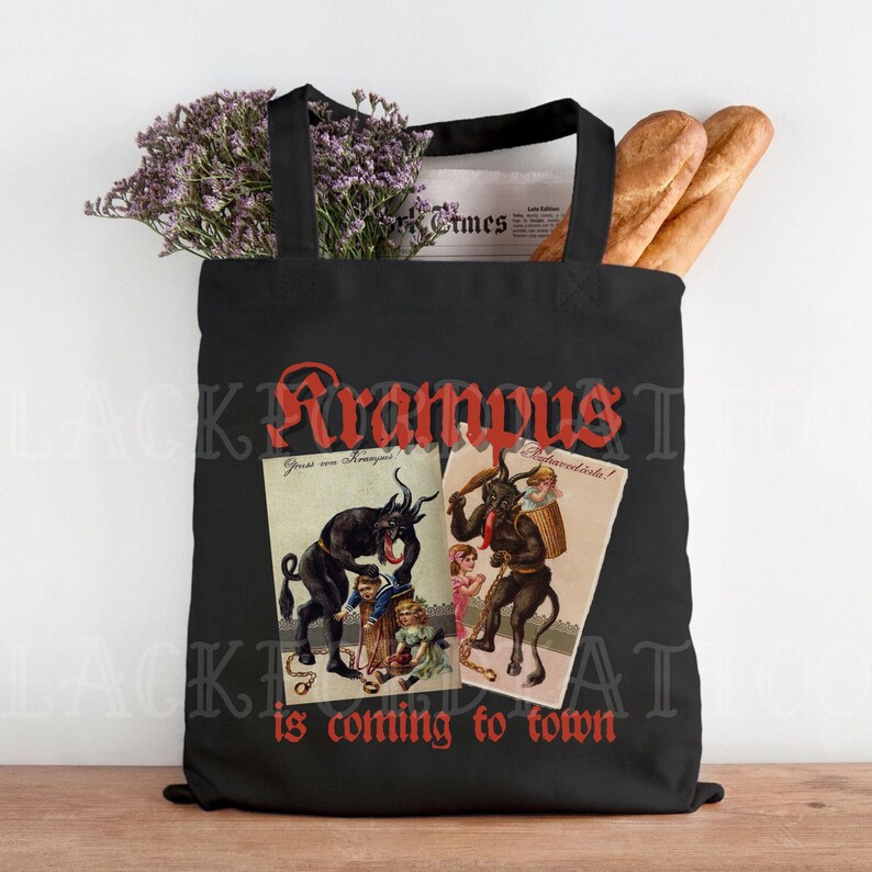 May include: Black tote bag featuring a red "Krampus is coming to town" graphic. The graphic includes two vintage illustrations of Krampus, a horned, demonic figure, with children.