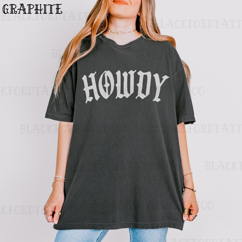May include: A black oversized t-shirt with the word "HOWDY" printed in white in a gothic font.
