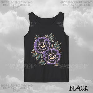 May include: Black tank top featuring a floral design of two purple roses with yellow centers and green leaves. The text "SHOP BLACKFORDTATTOO ONLY AVAILABLE ON ETSY" is printed around the top.