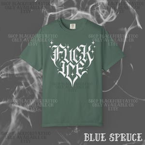 May include: Blue spruce t-shirt with a white graphic that reads "Fuck Me" in a heart shape. The shirt has short sleeves and a crew neck. The text "SHOP BLACKFORDTATTOO ONLY AVAILABLE ON ETSY" is repeated around the shirt.