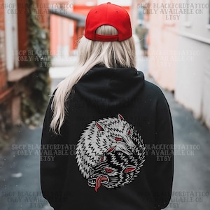 May include: A black hoodie with a circular wolf design on the back, featuring two wolf heads in black and white with red eyes and tongues. A red baseball cap is worn. The text "SHOP BLACKFORDTATTOO ONLY AVAILABLE ON ETSY" is visible.