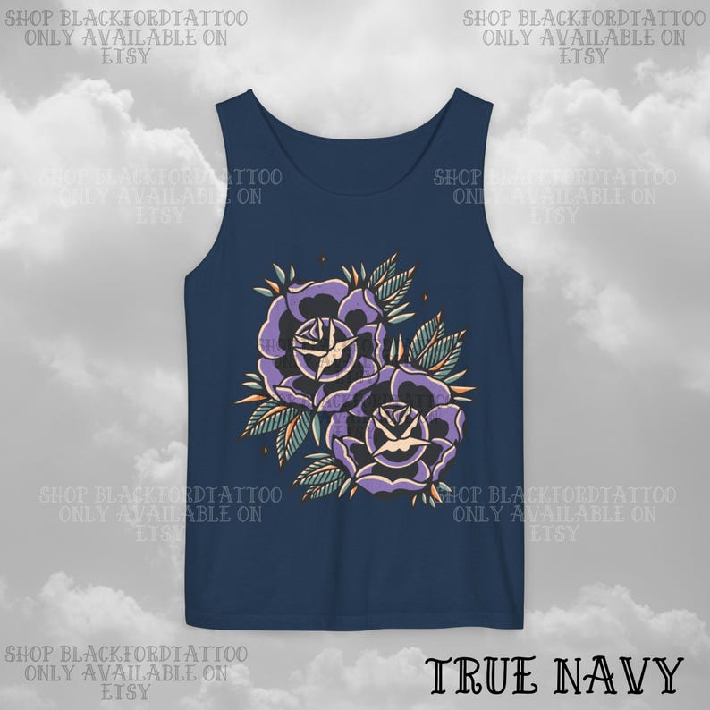 May include: A navy blue tank top featuring a floral design of two purple roses with green leaves and orange accents. The text "TRUE NAVY" is at the bottom. The top has the text "SHOP BLACKFORDTATTOO ONLY AVAILABLE ON ETSY" repeated around the top.
