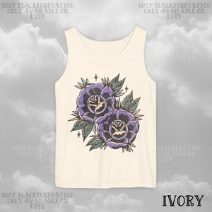 May include: Ivory tank top featuring a vintage-style tattoo design of two purple roses with green leaves and star accents. The text "SHOP BLACKFORDTATTOO ONLY AVAILABLE ON ETSY" is printed around the top.