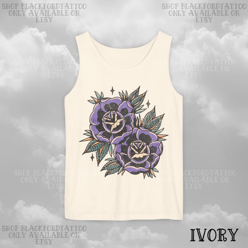 May include: Ivory tank top featuring a vintage-style tattoo design of two purple roses with green leaves and star accents. The text "SHOP BLACKFORDTATTOO ONLY AVAILABLE ON ETSY" is printed around the top.