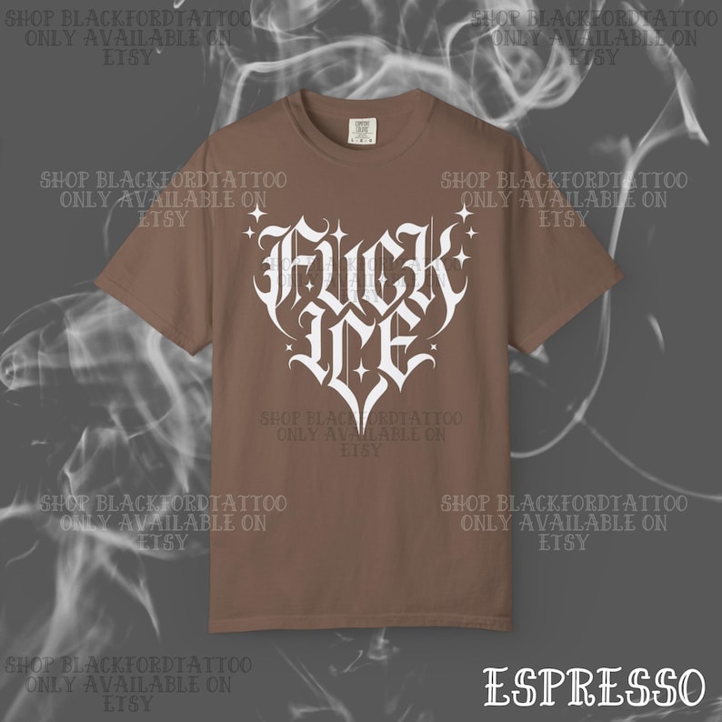 May include: Espresso-colored t-shirt with a white, stylized heart-shaped graphic that reads "FUCK ME". The shirt has short sleeves and a crew neck. The text "SHOP BLACKFORDTATTOO ONLY AVAILABLE ON ETSY" is printed around the shirt.