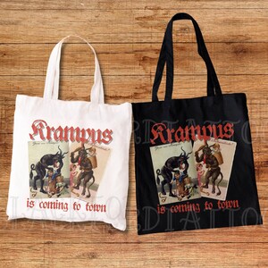 May include: Two tote bags, one white and one black, featuring a vintage illustration of Krampus, a mythical creature, on each. The text "Krampus is coming to town" is printed on both bags.