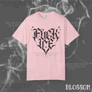 May include: A light pink t-shirt with a black gothic heart design that reads "Fuck Me". The shirt has short sleeves and a crew neck. The text "Shop Blackfordtattoo Only Available on Etsy" is printed around the shirt.