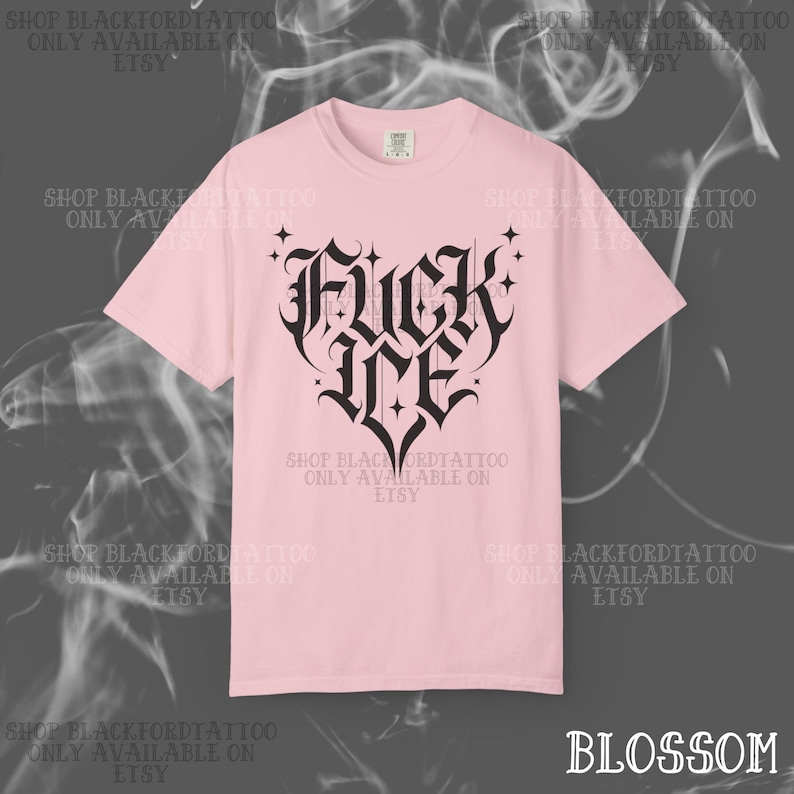 May include: A light pink t-shirt with a black gothic heart design that reads "Fuck Me". The shirt has short sleeves and a crew neck. The text "Shop Blackfordtattoo Only Available on Etsy" is printed around the shirt.