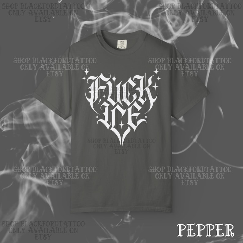 May include: Pepper-colored t-shirt with a white graphic that reads "Fuck Me" in a gothic font, shaped like a heart. The shirt has a crew neck and short sleeves. The text "Pepper" is at the bottom right.
