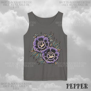 May include: A gray tank top featuring a tattoo-style design of two purple roses with green leaves and yellow accents. The text "SHOP BLACKFORDTATTOO ONLY AVAILABLE ON ETSY" is printed around the top. The word "PEPPER" is printed at the bottom.