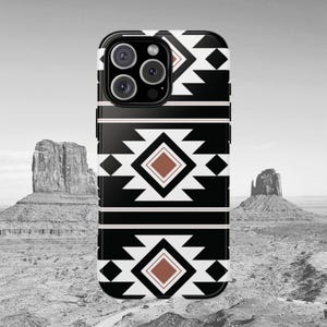 May include: Black and white geometric phone case with a brown diamond pattern. The case is designed for an iPhone with a camera bump.