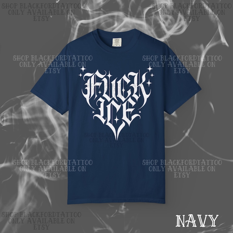 May include: Navy blue t-shirt with a white gothic font design that reads "FUCK ME" in a heart shape. The shirt has short sleeves and a crew neck. The text "NAVY" is at the bottom right.