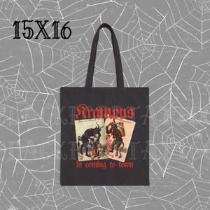 May include: Black canvas tote bag featuring a red graphic of a Krampus figure and the text "Krampus is coming to town".