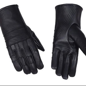 May include: A pair of black leather gloves with a textured design. The gloves have a long cuff and are made of soft, supple leather.