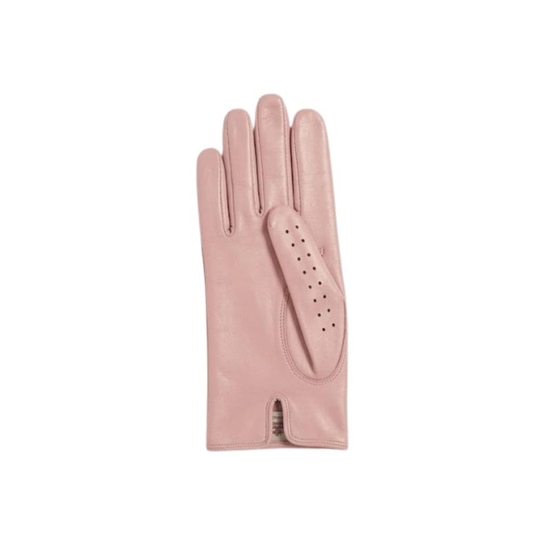 May include: A light pink leather glove featuring a smooth finish and a thumb section detailed with a vertical row of small ventilation perforations. The glove has a straight wrist opening with a small notch at the center of the bottom edge.