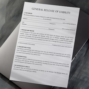 May include: A document titled "GENERAL RELEASE OF LIABILITY" with text in black font. The document is on a gray surface. The text includes sections on parties, release and waiver, assumption of risk, indemnification, and no admission of liability.