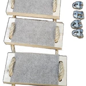 May include: A set of six wooden cat climbing steps with rope and carpeted surfaces. The steps are connected by a rope and have metal clips for attaching to a cat tree or other surface.