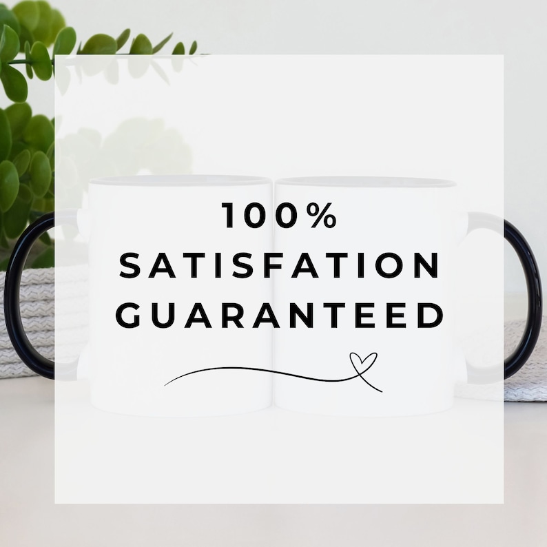 Promotional image featuring two white ceramic mugs with black handles in the background. A transparent overlay with bold black text reads '100% Satisfaction Guaranteed,' accompanied by a decorative heart flourish. Minimalist and modern design with greenery and a neutral backdrop.
