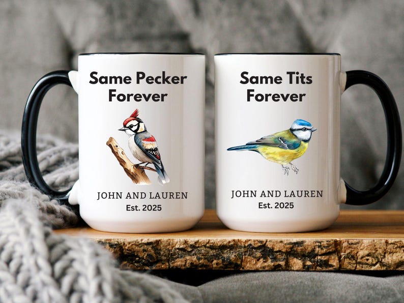 Set of two white ceramic mugs with black handles featuring humorous bird-themed designs. One mug has a woodpecker with the phrase 'Same Pecker Forever,' and the other has a blue tit with 'Same Tits Forever.' Personalized with names and 'Est. 2025.'
