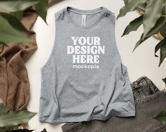 May include: Gray sleeveless tank top with the text "YOUR DESIGN HERE mockopia" printed on the front.