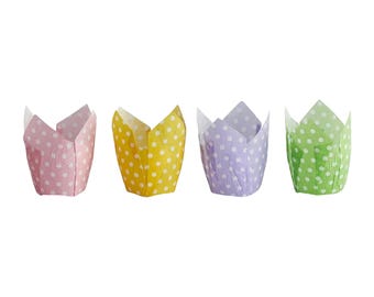 May include: Four tulip-style cupcake liners arranged in a row. Each liner features a white polka dot pattern on a solid background color. The colors from left to right are light pink, bright yellow, soft lavender, and light green.