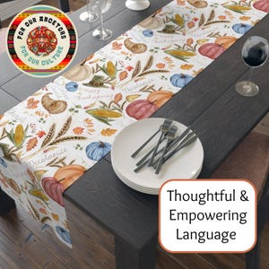 May include: Thanksgiving-themed table runner with pumpkins, corn, and fall leaves. The runner has the words "Happy Thanksgiving" and "Decolonize" printed on it. A round coaster with the text "For Our Ancestors For Our Culture" is also visible.