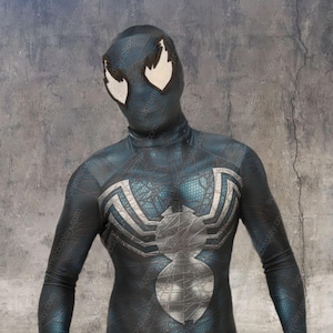 May include: A black and blue spandex costume with a white spider symbol on the chest. The costume has a textured, web-like pattern throughout. The costume has white eyes with black flames.