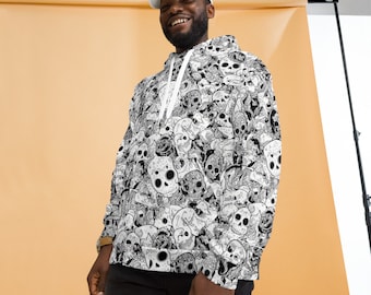 May include: A white hoodie with a black and white skull print. The hoodie has a drawstring hood and a kangaroo pocket. The model is wearing a white baseball cap.