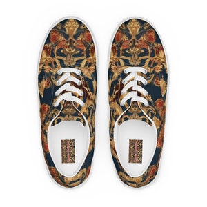 May include: A pair of white canvas low-top sneakers with a blue and gold patterned design. The pattern features intricate details and a repeating motif.