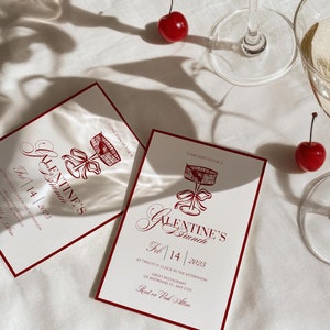 Pode incluir: Um cartão de convite vermelho e branco para um brunch de Galentine's em 14 de fevereiro de 2025. O convite apresenta um coração vermelho com um design de gaiola e o texto "Galentine's Brunch" em uma fonte vermelha de estilo manuscrito.