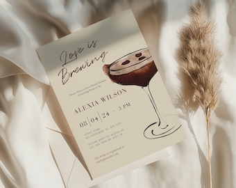 May include: A bridal shower invitation with the text "Love is Brewing" in elegant script. The invitation features a watercolor illustration of a cocktail and includes event details such as the date, time, and location.