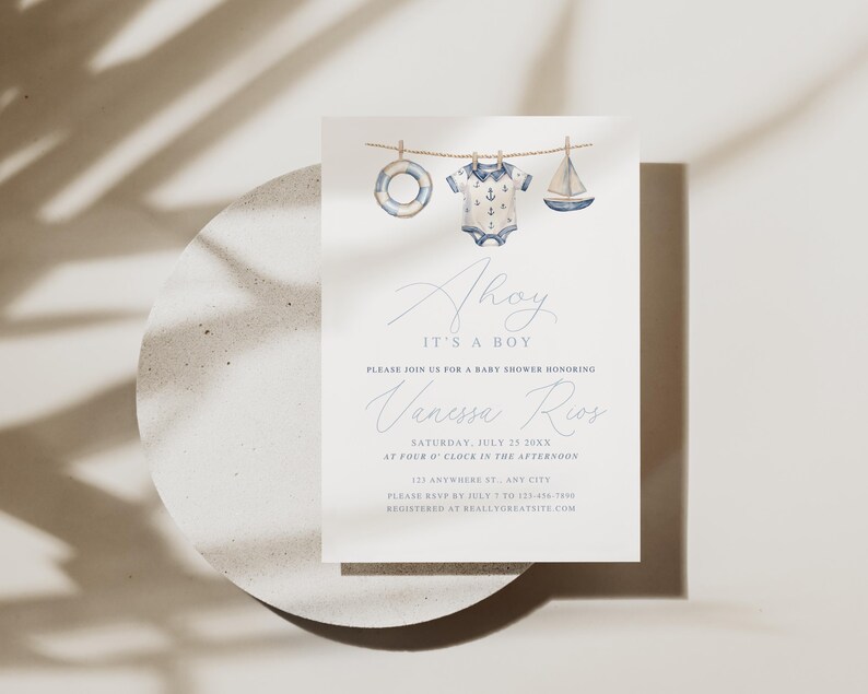May include: A baby shower invitation with a nautical theme. The invitation features watercolor illustrations of a life preserver, a onesie, and a sailboat hanging on a clothesline. The text reads "Ahoy, It's a Boy" and includes event details.