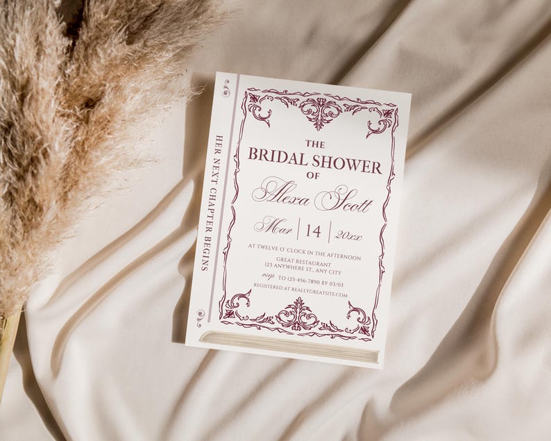 May include: A white invitation card with a burgundy floral border and text that reads "THE BRIDAL SHOWER of Alexa Scott Mar 14 202x". The card is designed to look like a book. The words "HER NEXT CHAPTER BEGINS" are printed vertically on the side.