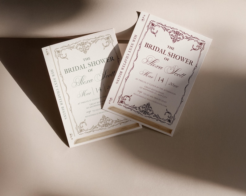 May include: Ivory bridal shower invitations with burgundy and gold accents. The invitations feature ornate borders and the text "The Bridal Shower of Alexa Scott" with event details. The phrase "Her Next Chapter Begins" is also present.