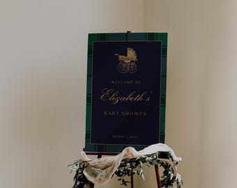 May include: A blue and green plaid baby shower sign with gold lettering. The sign says "Welcome to Elizabeth's Baby Shower" and "March 3, 2023". A gold baby carriage is pictured at the top of the sign.