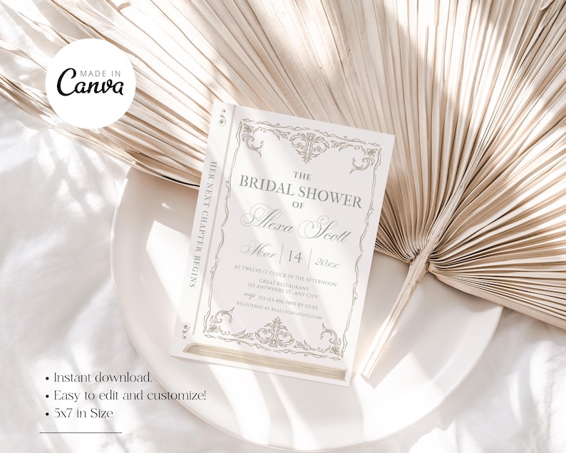 May include: A bridal shower invitation in a book-like design. The invitation is white with gold-colored decorative elements and text. The text reads "The Bridal Shower of Alexa Scott" and includes the date, March 14, 2022. The invitation is 5x7 inches.