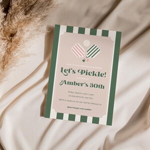 May include: A green and white striped invitation with a pink and green pickleball paddle graphic. The text reads "Let's Pickle! Amber's 30th" with details about the event.