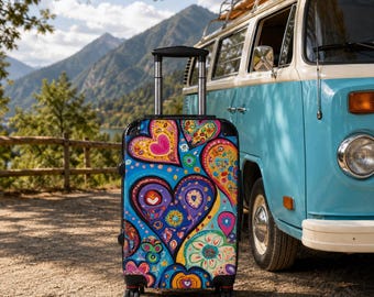 May include: A rolling suitcase featuring a vibrant, multi-colored pattern of stylized hearts and floral motifs in shades of blue, purple, pink, orange, and yellow. The luggage has a retractable black handle and four wheels, standing upright.