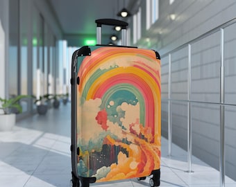 May include: A rolling suitcase with a vibrant rainbow design. The suitcase features a black frame, handle, and wheels. The artwork includes a colorful rainbow, clouds, and a flowing, abstract landscape in shades of orange, yellow, blue, and pink.