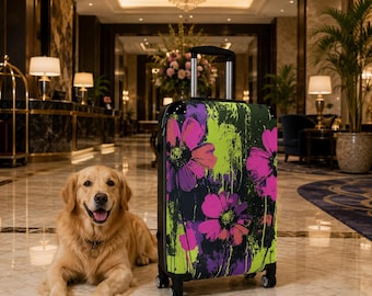 May include: A rolling suitcase featuring a vibrant floral pattern with large pink and purple flowers set against a black and lime green abstract background, equipped with a retractable silver handle and four black spinner wheels for mobility.