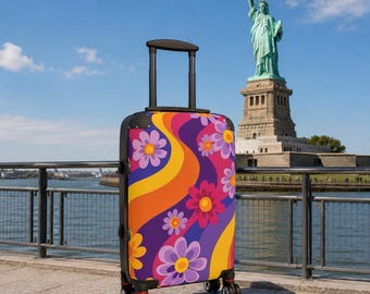 May include: A rolling suitcase featuring a vibrant, multi-colored pattern of wavy orange and purple stripes interspersed with stylized pink and purple flowers. The luggage has a black frame, a retractable top handle, and four black swivel wheels.