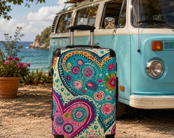 May include: A rolling suitcase featuring a vibrant, multi-colored pattern of stylized hearts, circular motifs, and floral shapes in shades of turquoise, magenta, yellow, and white. The luggage has a black frame, a retractable handle, and wheels.