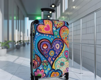 May include: A colorful suitcase with a pattern of hearts and flowers. The suitcase is blue, pink, yellow, green, and purple. It has a black handle and four wheels.