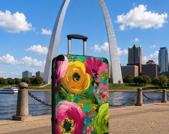 May include: A rolling suitcase featuring a vibrant floral pattern with large yellow, pink, and lime green painted flowers on a teal background. The luggage has a black frame, black corner protectors, and a retractable silver handle on top.