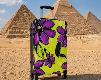 May include: A rolling suitcase featuring a vibrant lime green background with a bold, hand-drawn style floral pattern in shades of purple and black. The luggage has a black frame, a retractable silver handle, and four black spinner wheels.
